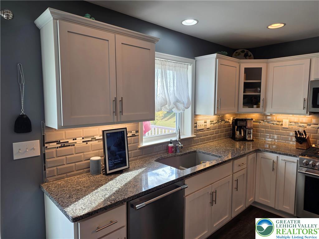 3393 Crestview Lane Walnutport, PA 18088 - Photo 21 of 68 a kitchen with stainless steel appliances granite countertop a sink and a stove