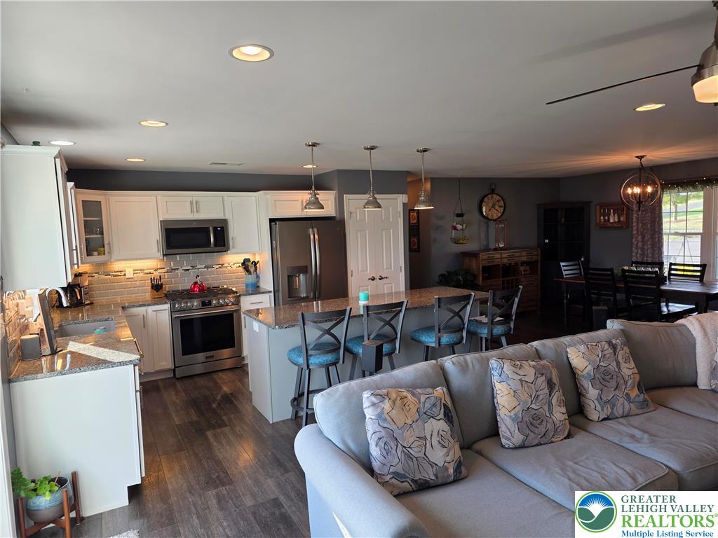 3393 Crestview Lane Walnutport, PA 18088 - Photo 24 of 68 a living room with furniture kitchen view and a refrigerator