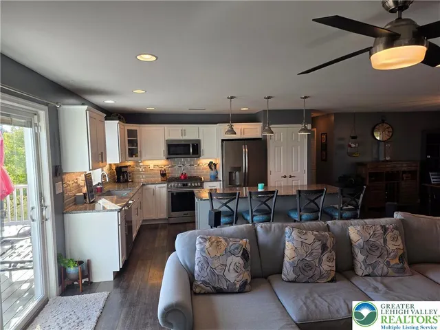 a view of a dining room with furniture wooden floor and chandelier