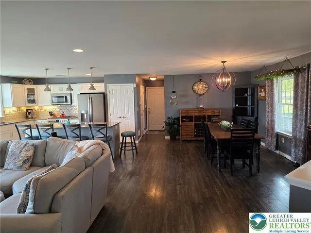 a living room with lots of furniture and a chandelier