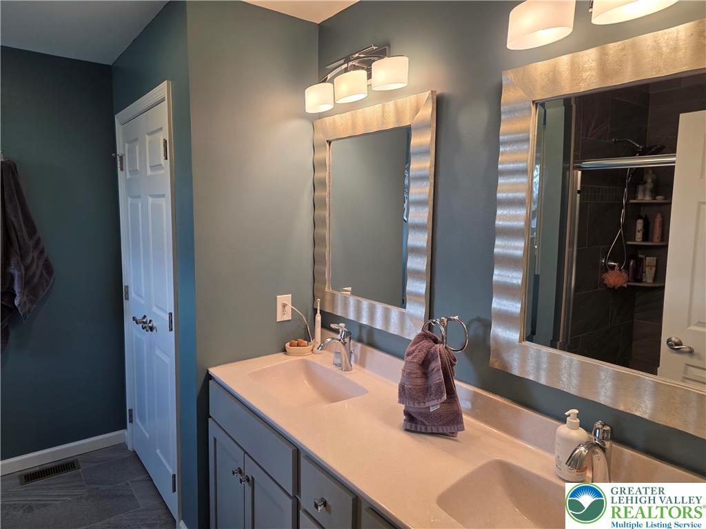 3393 Crestview Lane Walnutport, PA 18088 - Photo 42 of 68 a bathroom with a double vanity sink and a mirror