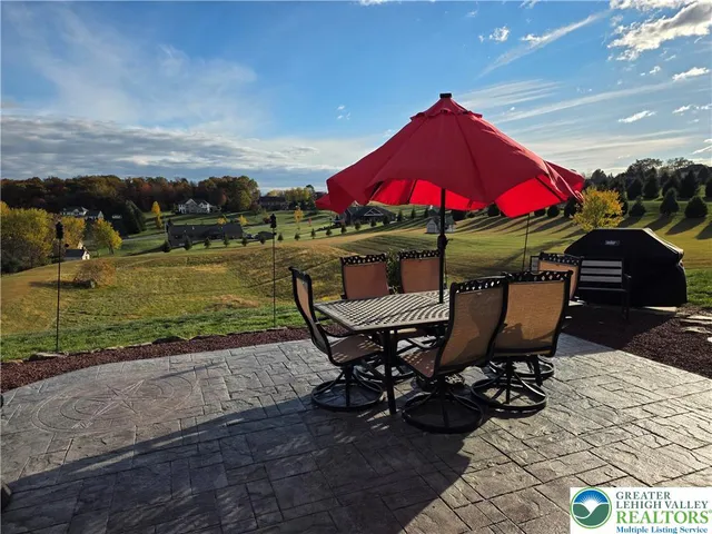 a view of a balcony with two chairs and a table