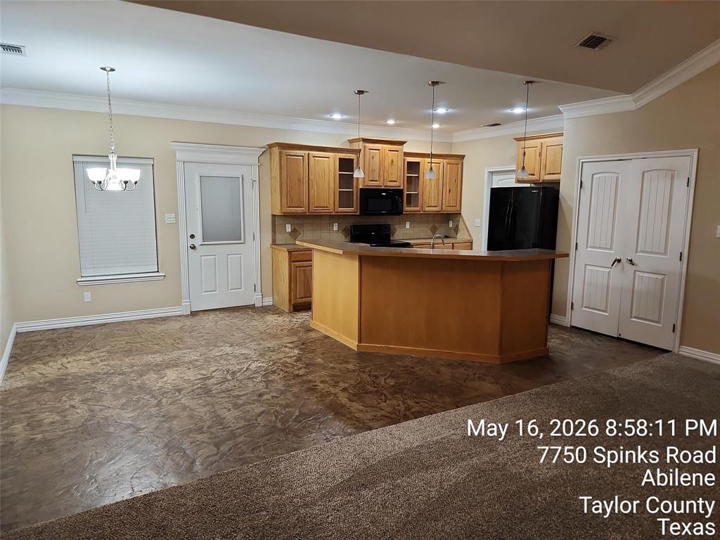 a kitchen with stainless steel appliances kitchen island granite countertop a refrigerator and a stove top oven