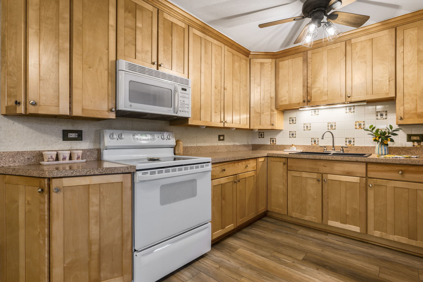 470 Oakwood Road Wauconda, IL 60084 - Photo 14 of 28 a kitchen with stainless steel appliances granite countertop a stove a sink and a microwave