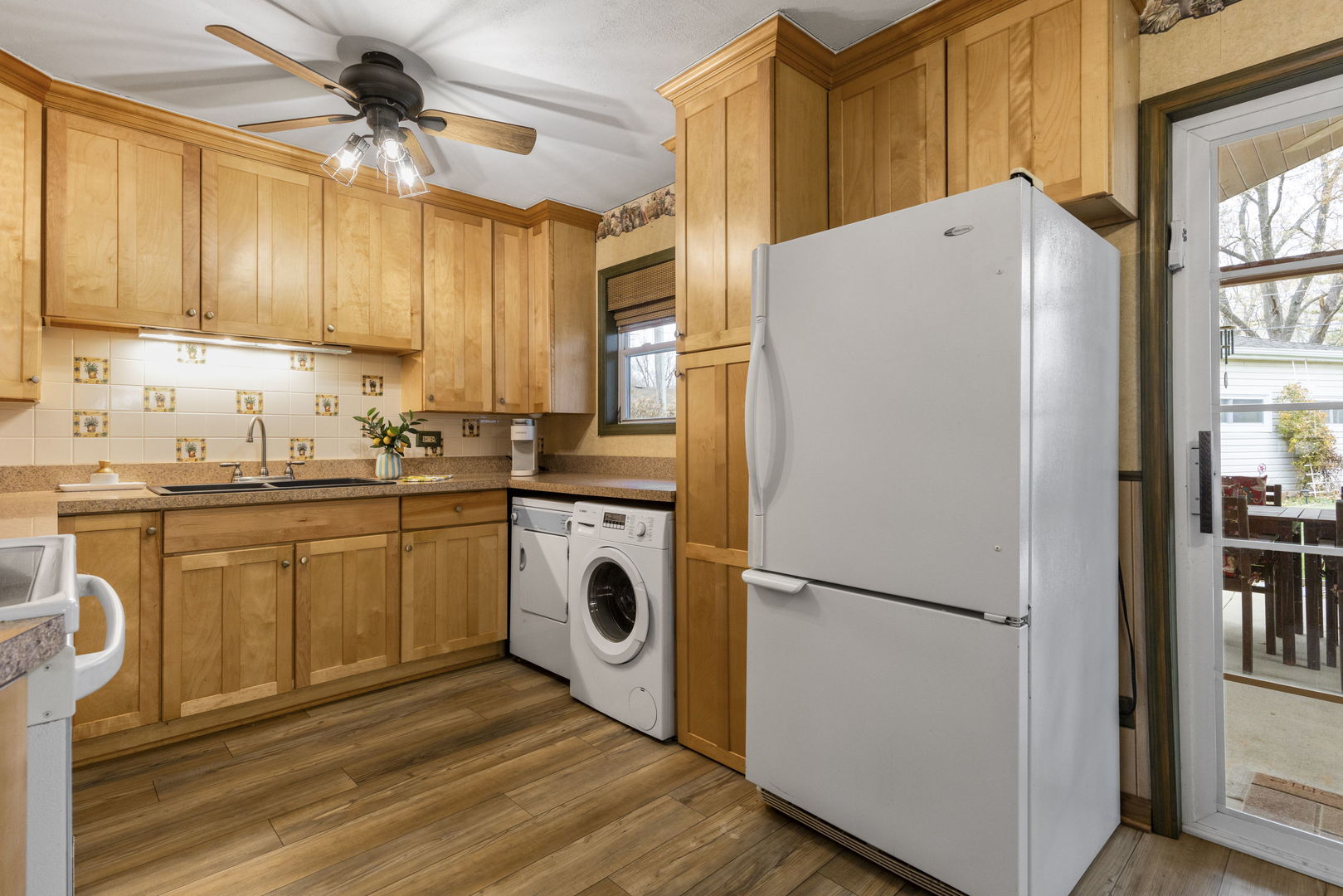 470 Oakwood Road Wauconda, IL 60084 - Photo 15 of 28 a kitchen with a refrigerator a sink and cabinets