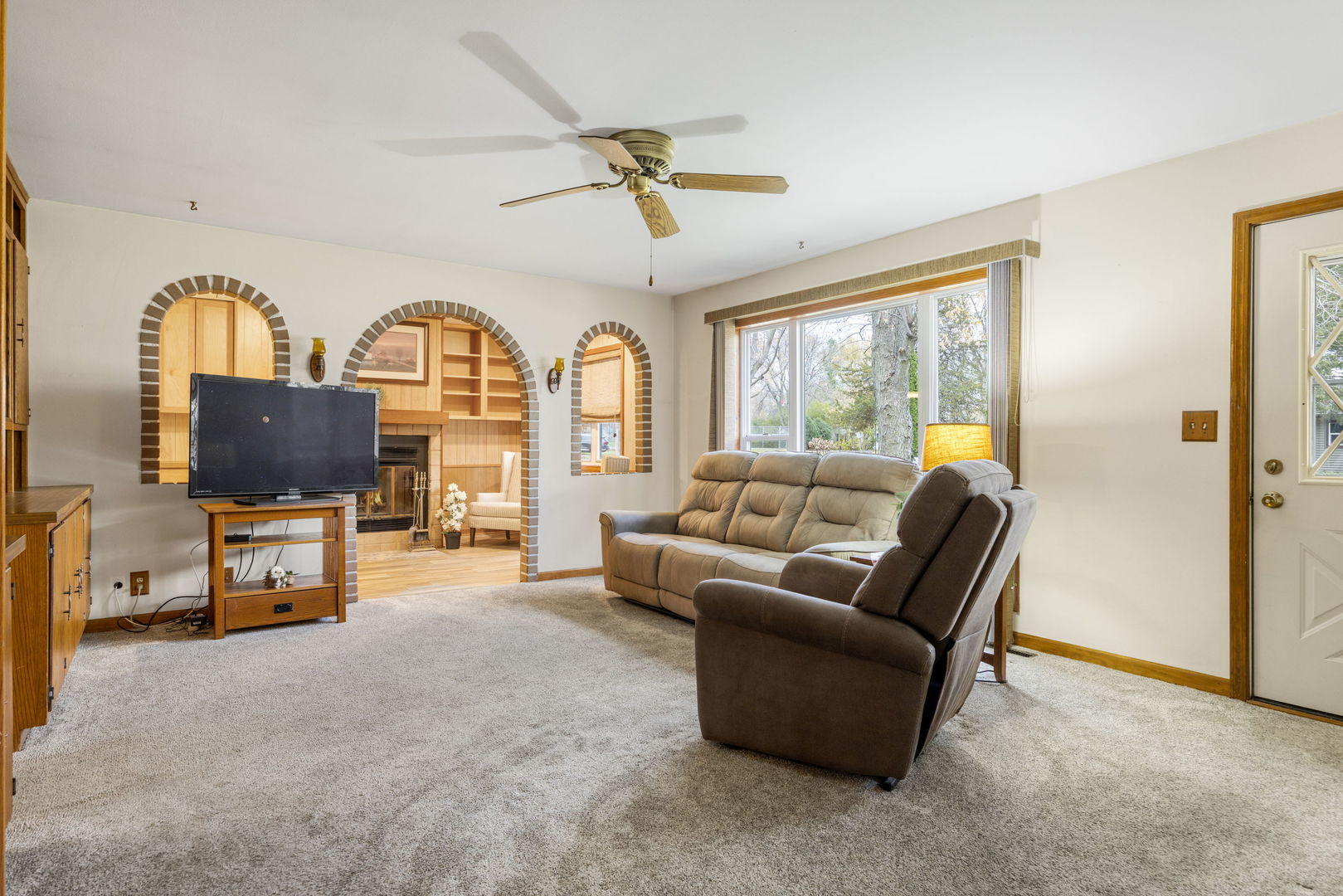 470 Oakwood Road Wauconda, IL 60084 - Photo 18 of 28 a living room with furniture a flat screen tv and a large window