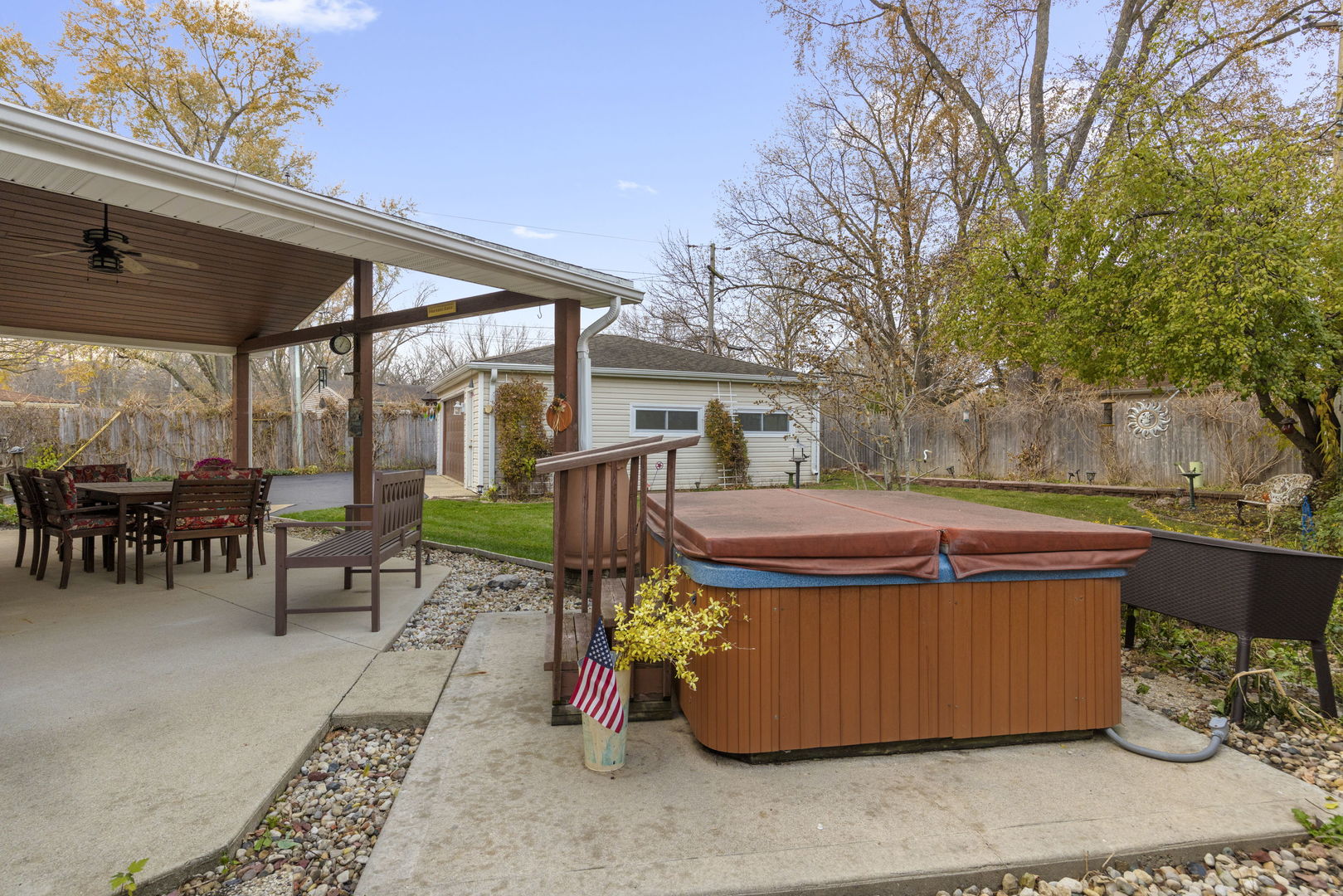 470 Oakwood Road Wauconda, IL 60084 - Photo 27 of 28 a view of a patio with table and chairs potted plants and a barbeque