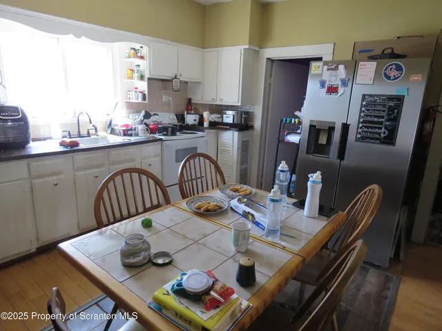 a kitchen with furniture and wooden floor