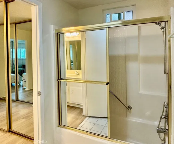 a bathroom with a glass shower door