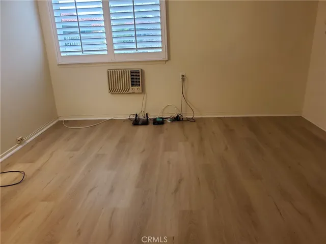 a view of a room with wooden floor and a window