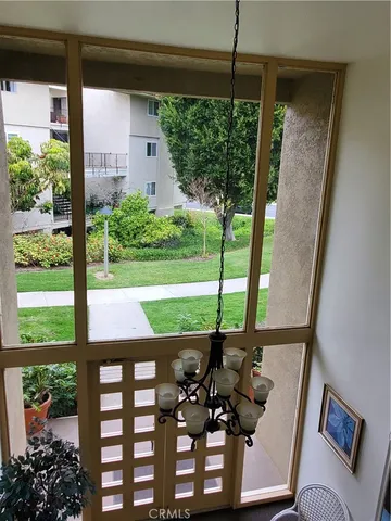 a view of a porch with furniture and garden