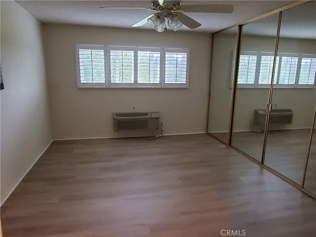 en empty room with windows and chandelier