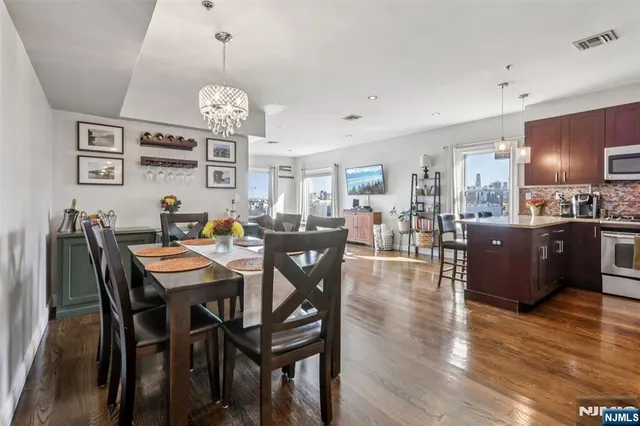 a view of a dining room with furniture wooden floor and chandelier