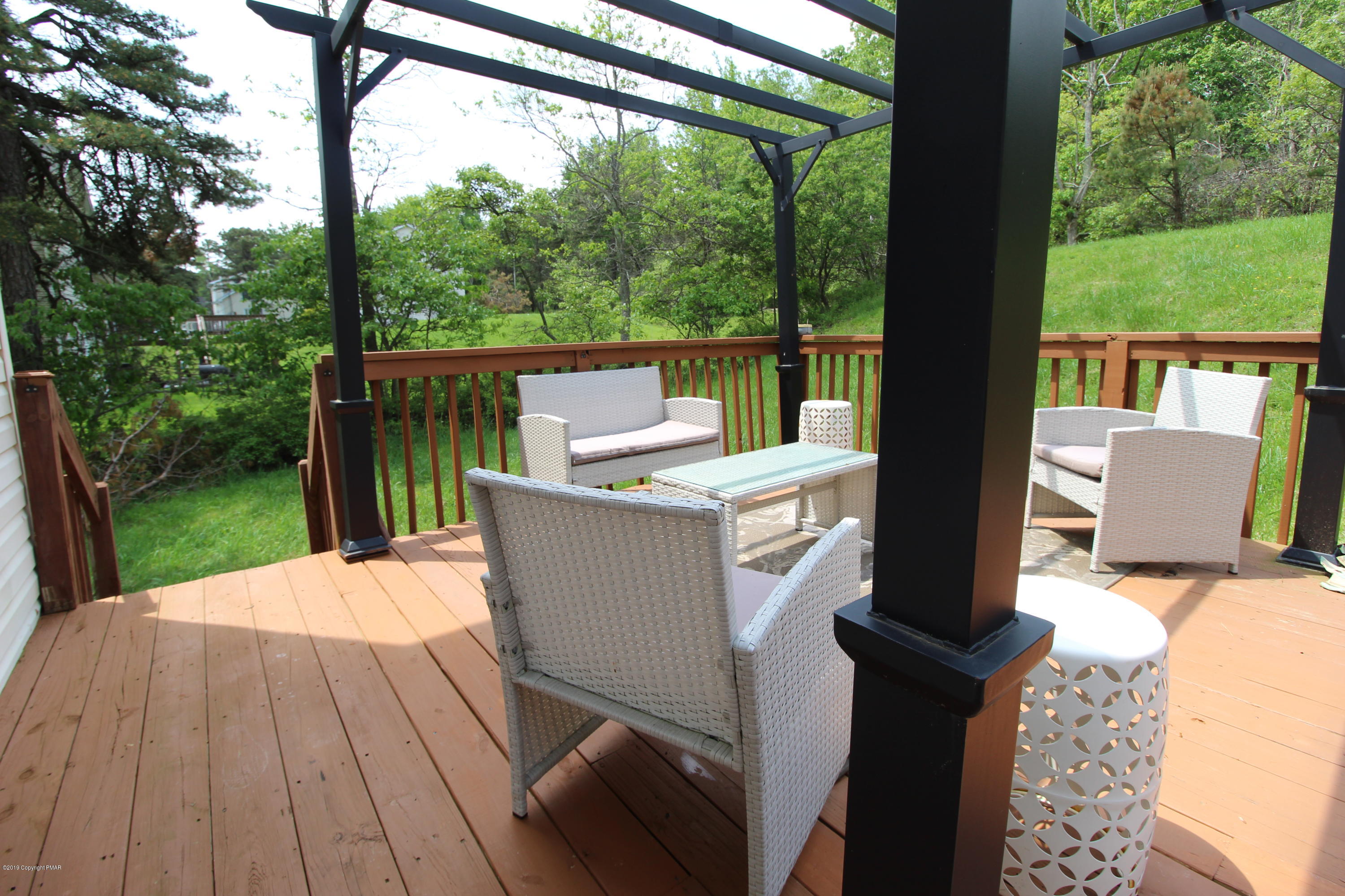 195 Granite Road Long Pond, PA 18334 - Photo 11 of 29 a view of a patio with a table chairs and a backyard