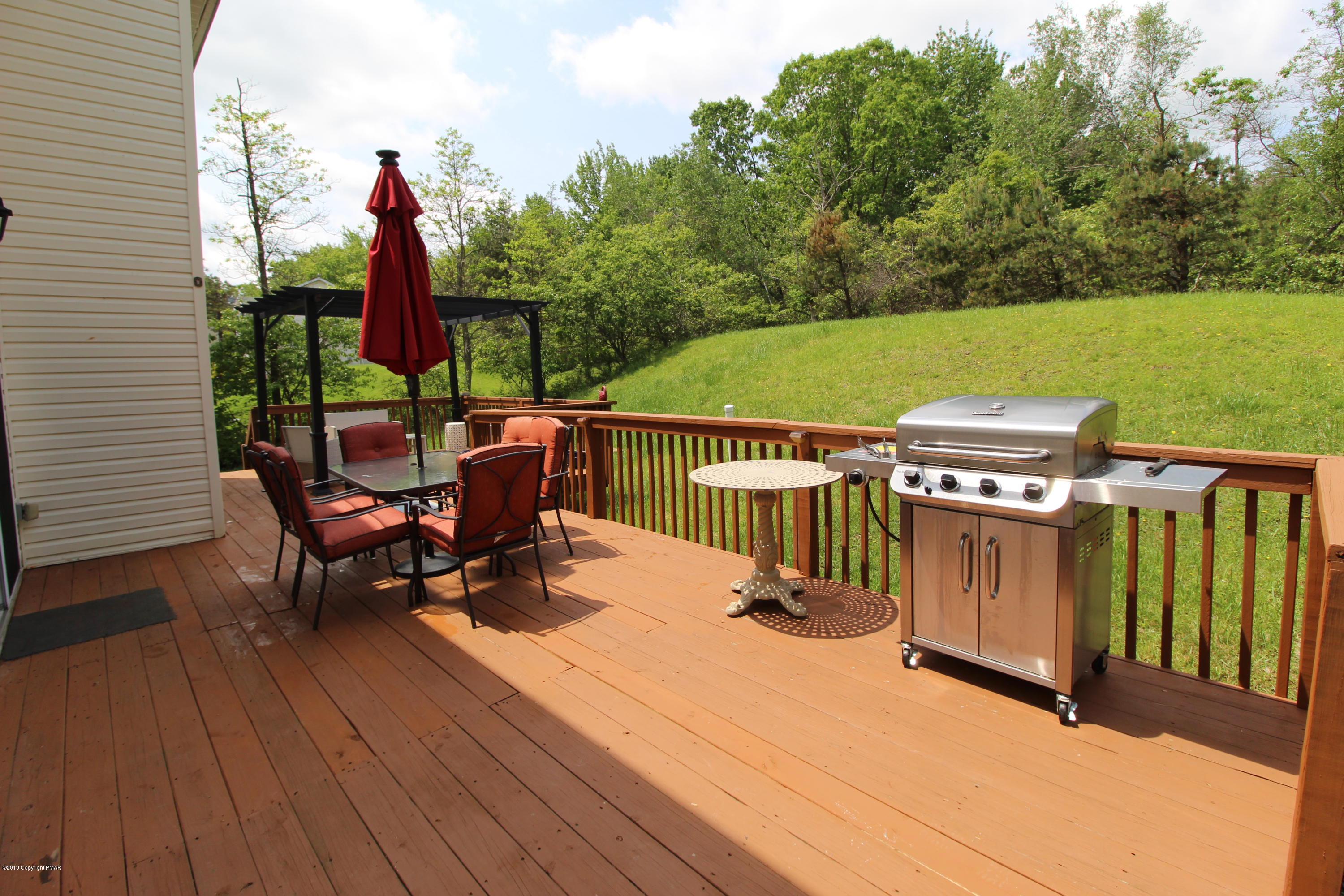 195 Granite Road Long Pond, PA 18334 - Photo 13 of 29 a view of a chairs and table on the wooden deck