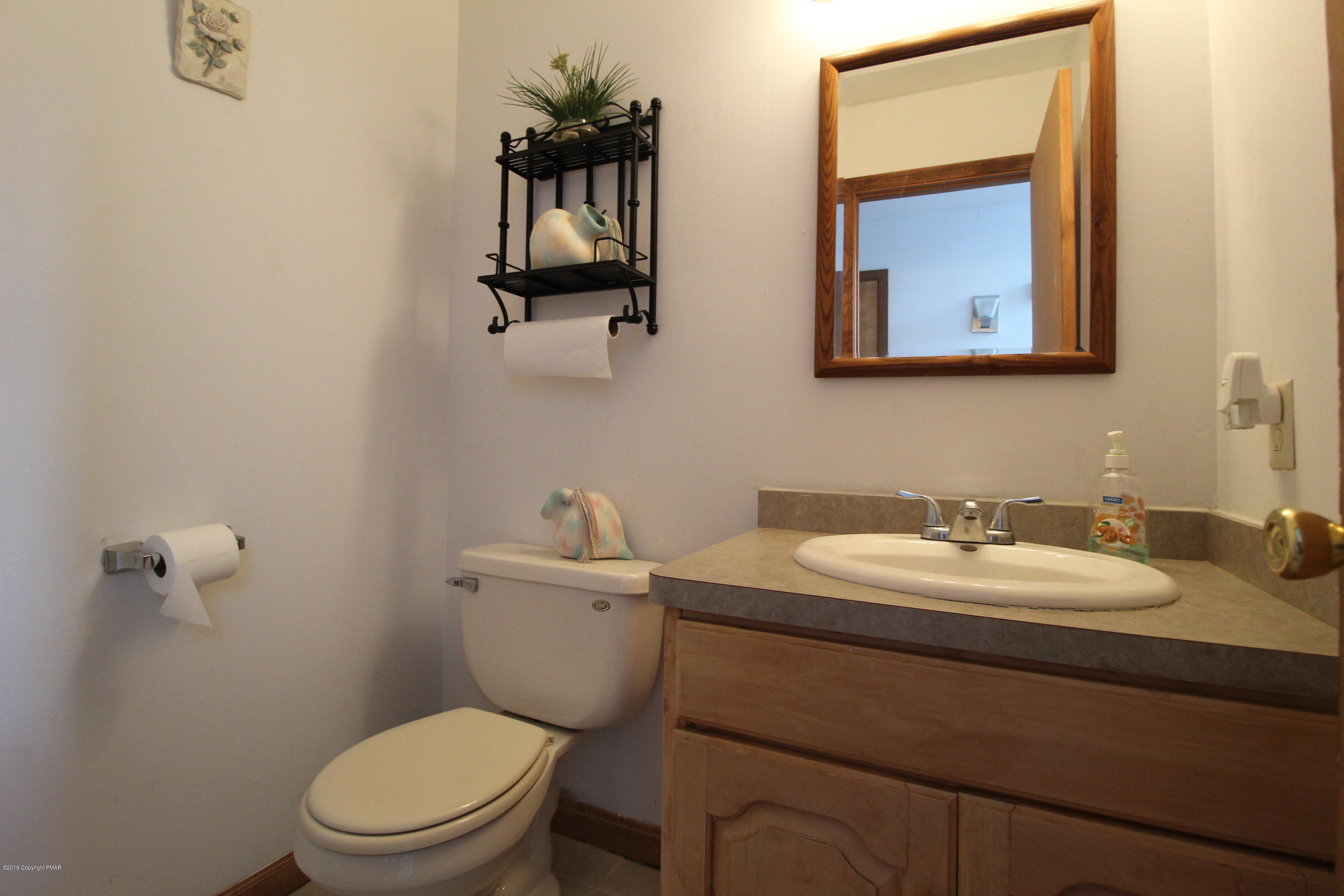 195 Granite Road Long Pond, PA 18334 - Photo 14 of 29 a bathroom with a toilet sink and mirror