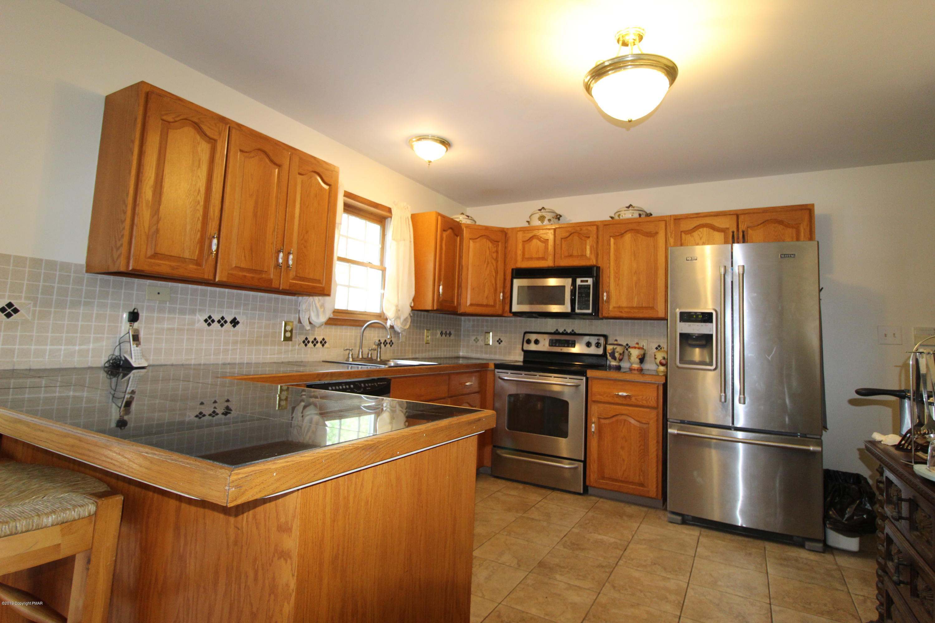 195 Granite Road Long Pond, PA 18334 - Photo 6 of 29 a kitchen with stainless steel appliances granite countertop a sink stove and refrigerator