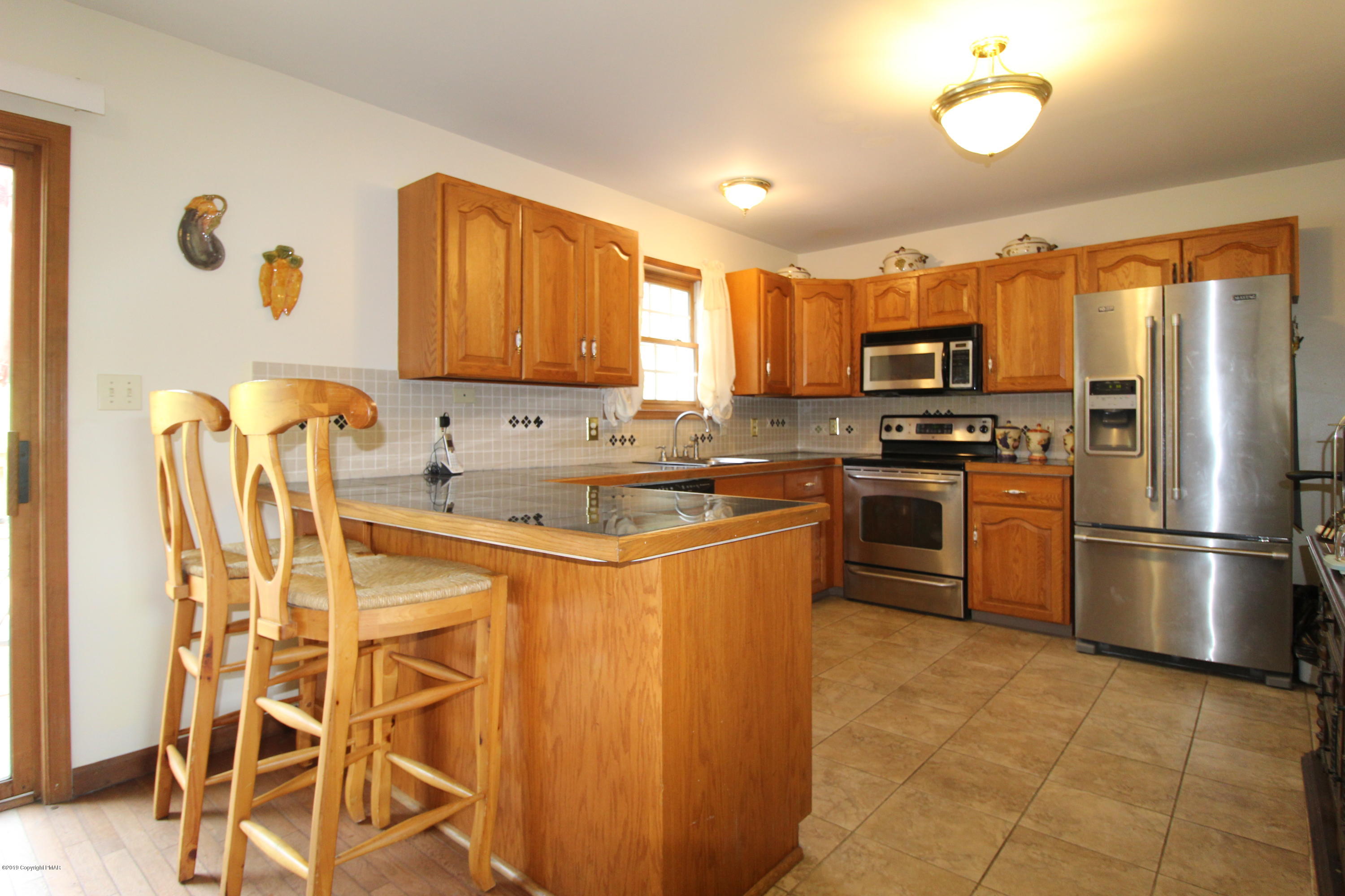 195 Granite Road Long Pond, PA 18334 - Photo 7 of 29 a kitchen with stainless steel appliances granite countertop a stove a sink dishwasher a refrigerator and a microwave