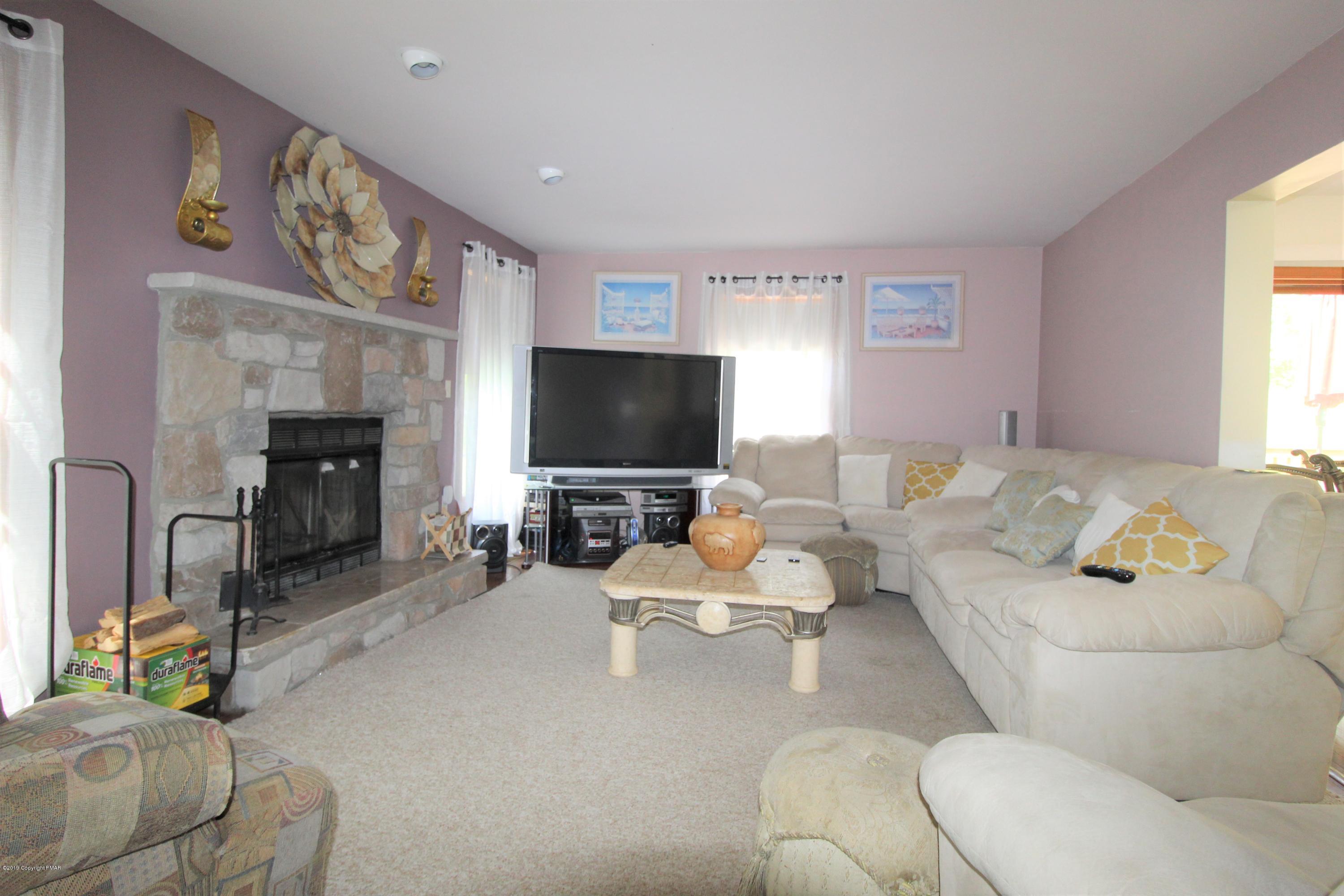 195 Granite Road Long Pond, PA 18334 - Photo 9 of 29 a living room with furniture and a flat screen tv