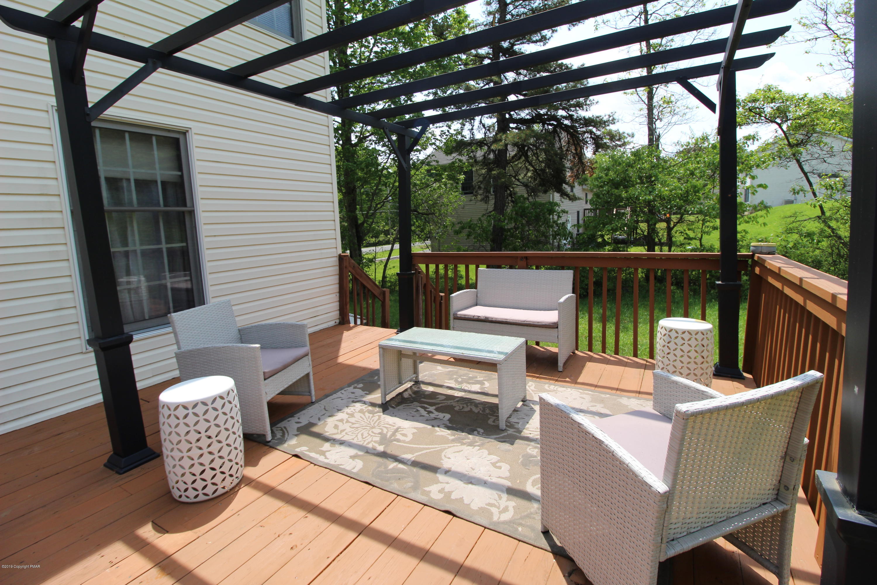 195 Granite Road Long Pond, PA 18334 - Photo 10 of 29 a view of a patio with couches chairs and a table and chairs with wooden floor