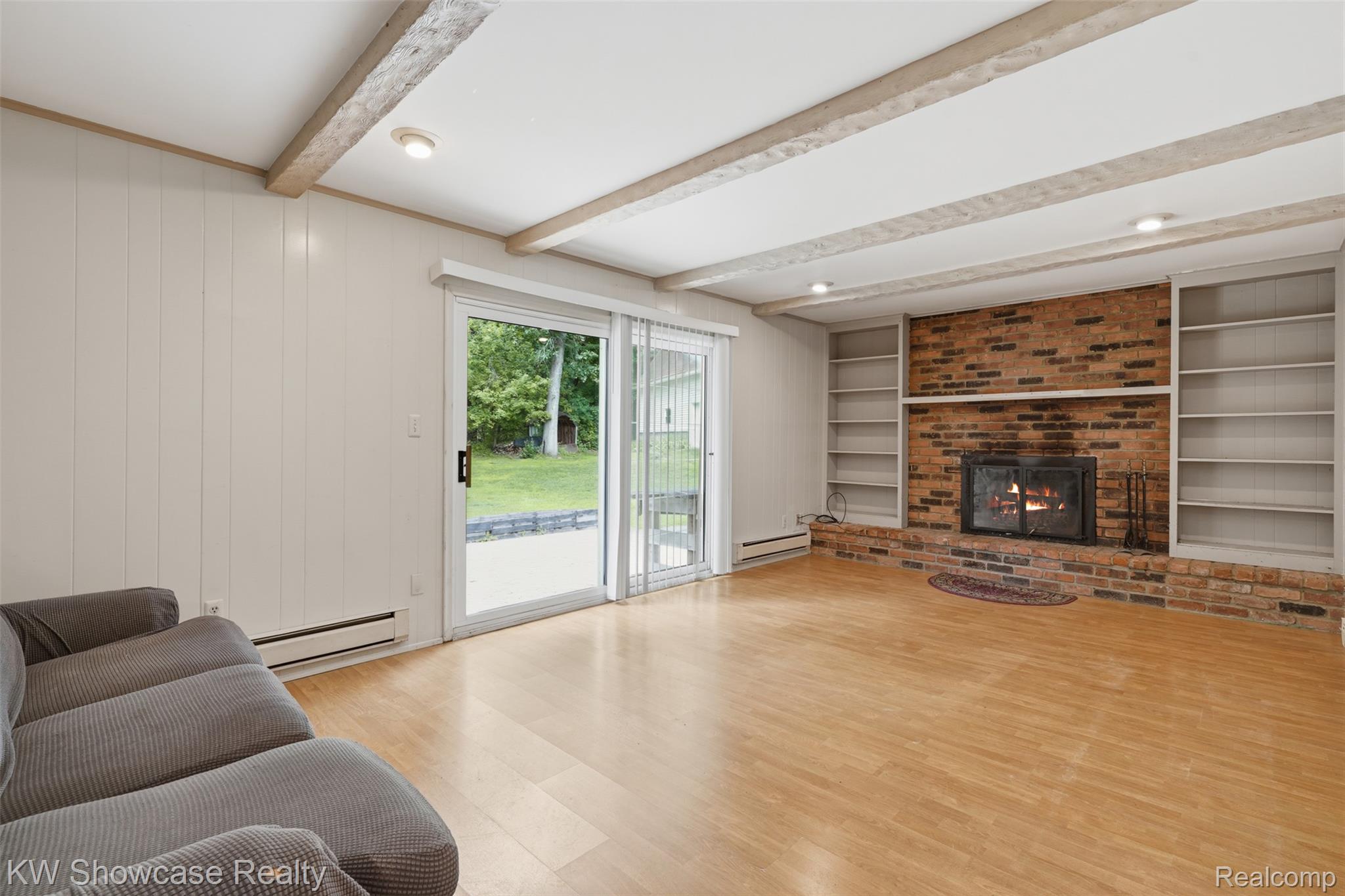 7125 Ridgewood Road Davisburg, MI 48350 - Photo 14 of 47 Family room w/ exposed beams, fireplace and doorwall to patio