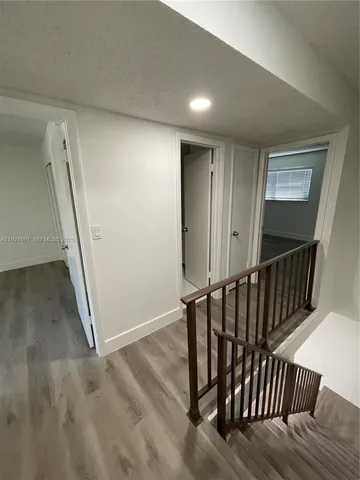 a view of a hallway with staircase