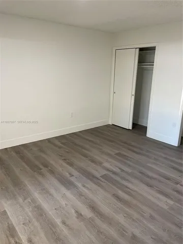 an empty room with wooden floor