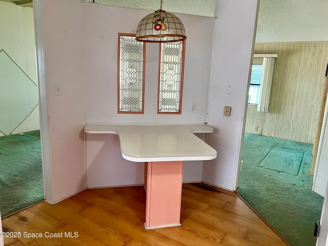 a view of a hallway with a sink and a mirror