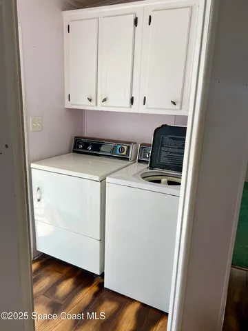 a view of washer and dryer with wooden floor