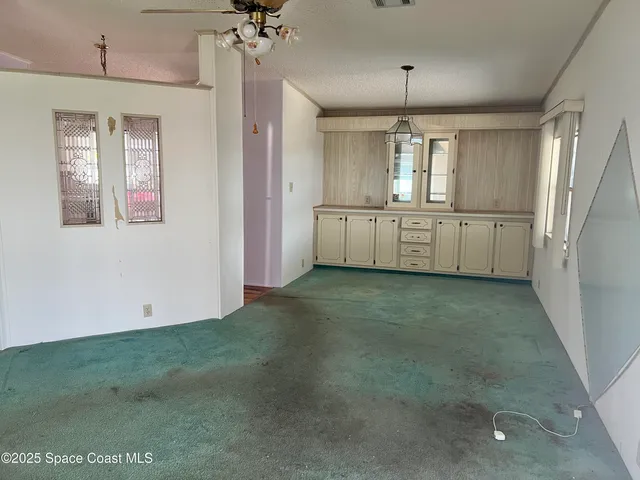 a view of a kitchen with a sink and cabinet