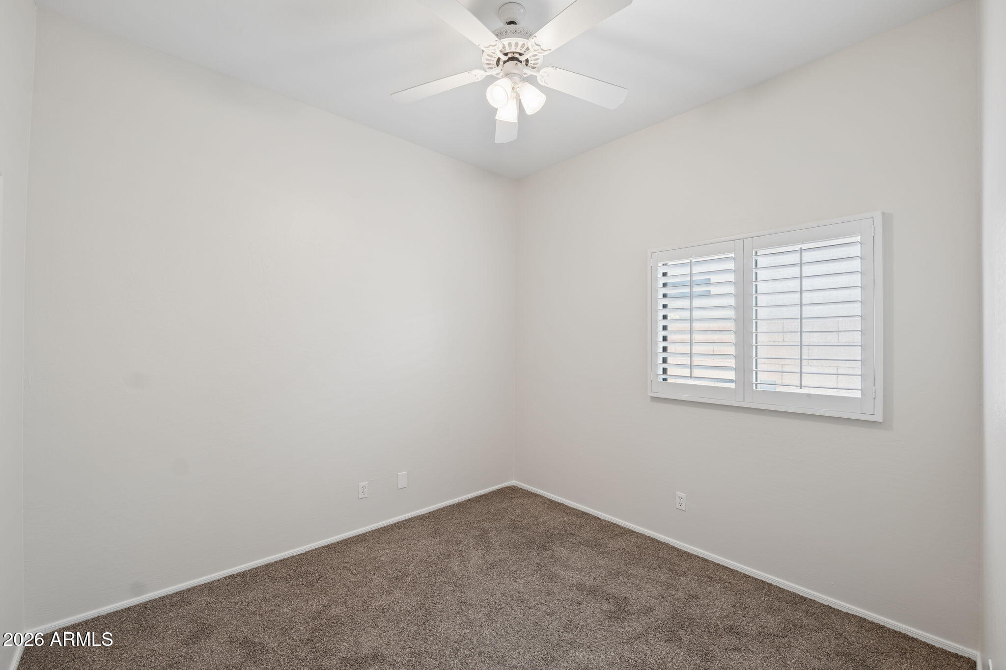 4418 East Jaeger Road Phoenix, AZ 85050 - Photo 23 of 42 an empty room with a window and a fan