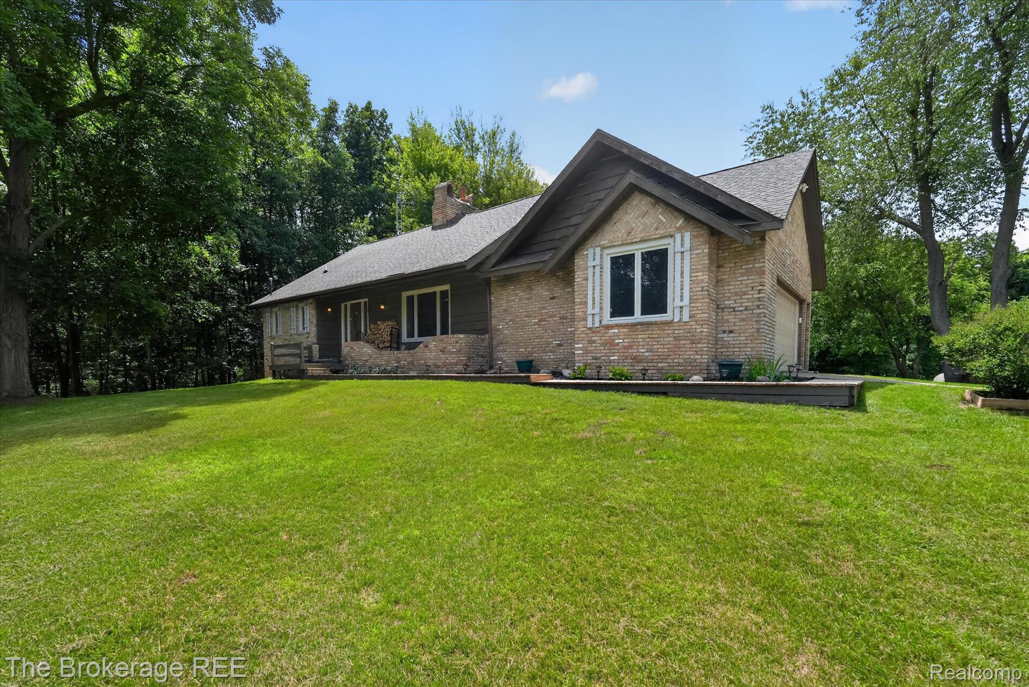 13269 North Genesee Road Clio, MI 48420 - Photo 2 of 67 Brick and siding exterior featuring a multi-pitched roofline and a prominent chimney