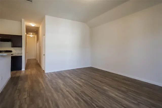 a view of a kitchen with wooden floor and a sink