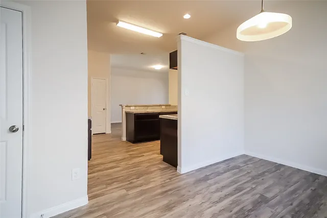 a view of a kitchen with a sink and a refrigerator