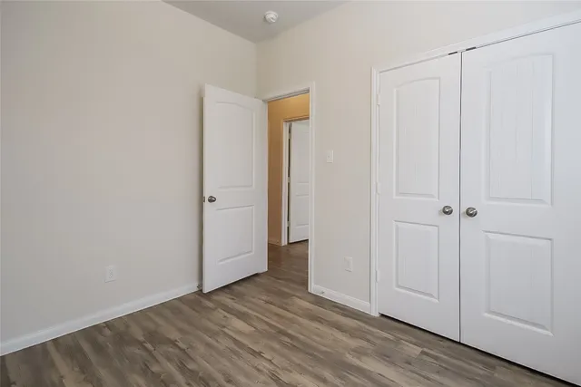 a view of a room with wooden floor