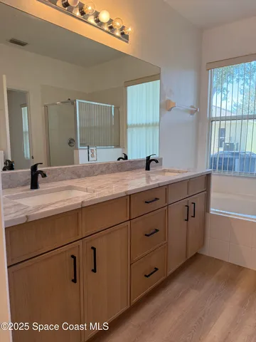 a bathroom with a sink a mirror and a bathtub
