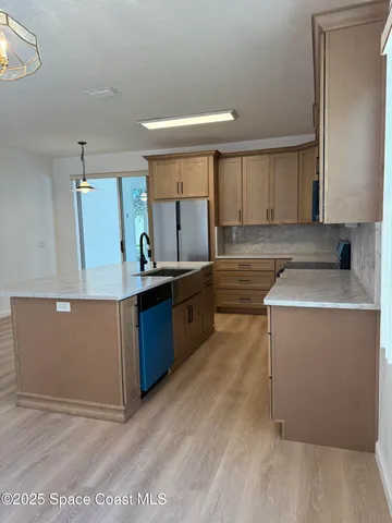 a kitchen with a sink cabinets and window