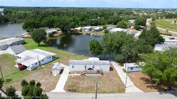 an aerial view of a house with garden space and lake view