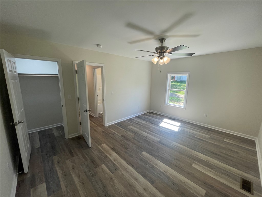 22 3rd Street Pendleton, SC 29670 - Photo 11 of 29 This spacious bedroom offers ample natural light and durable flooring, with convenient access to a closet and bathroom.