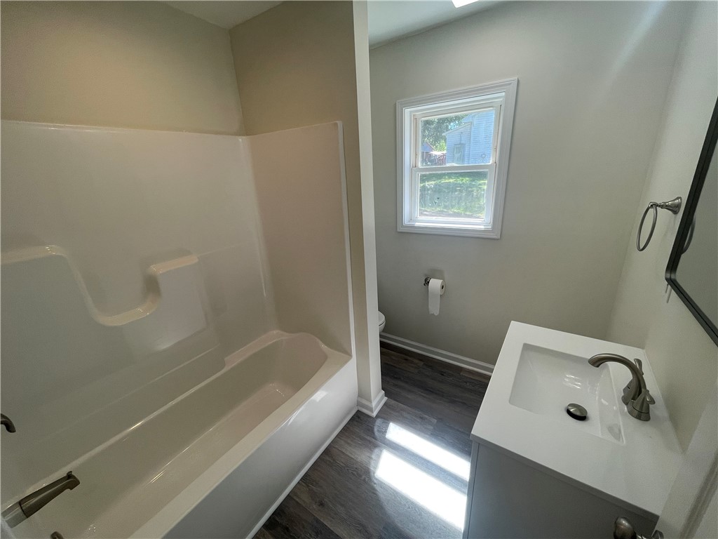 22 3rd Street Pendleton, SC 29670 - Photo 13 of 29 This bright bathroom features a clean vanity and a window, offering a refreshing space.