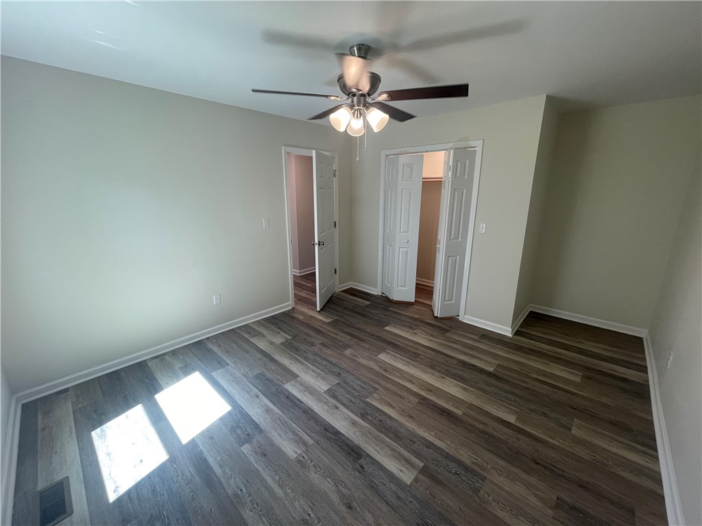 22 3rd Street Pendleton, SC 29670 - Photo 18 of 29 This spacious bedroom offers comfortable living with ample light and versatile flooring.