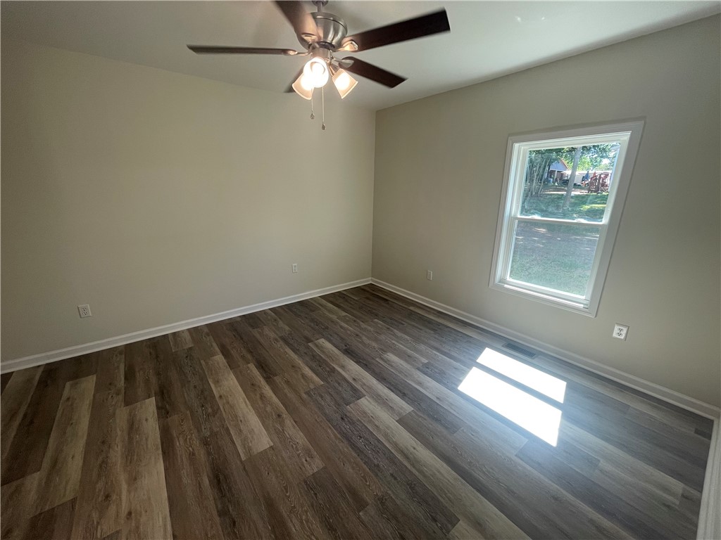 22 3rd Street Pendleton, SC 29670 - Photo 19 of 29 This airy room features durable flooring and a refreshing ceiling fan.