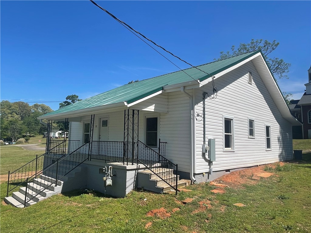 22 3rd Street Pendleton, SC 29670 - Photo 26 of 29 This inviting home offers classic appeal with a welcoming front porch, perfect for enjoying peaceful moments.