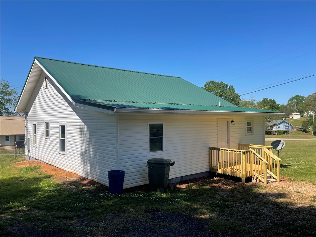 22 3rd Street Pendleton, SC 29670 - Photo 3 of 29 This charming home features a well-maintained exterior and a vibrant green roof.
