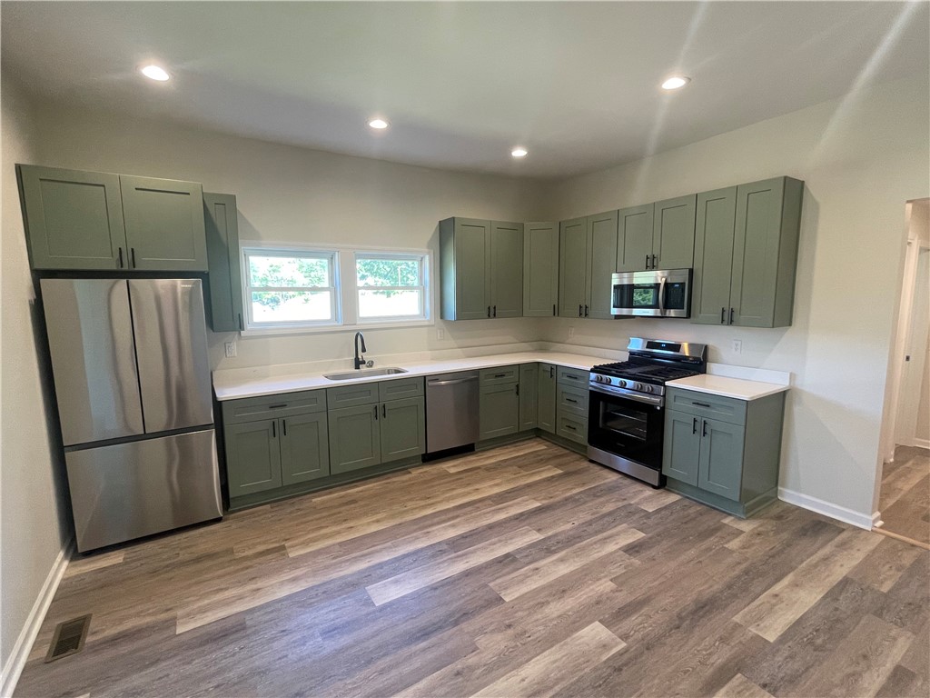 22 3rd Street Pendleton, SC 29670 - Photo 4 of 29 This bright kitchen features ample counter space and modern appliances, perfect for any culinary endeavor.