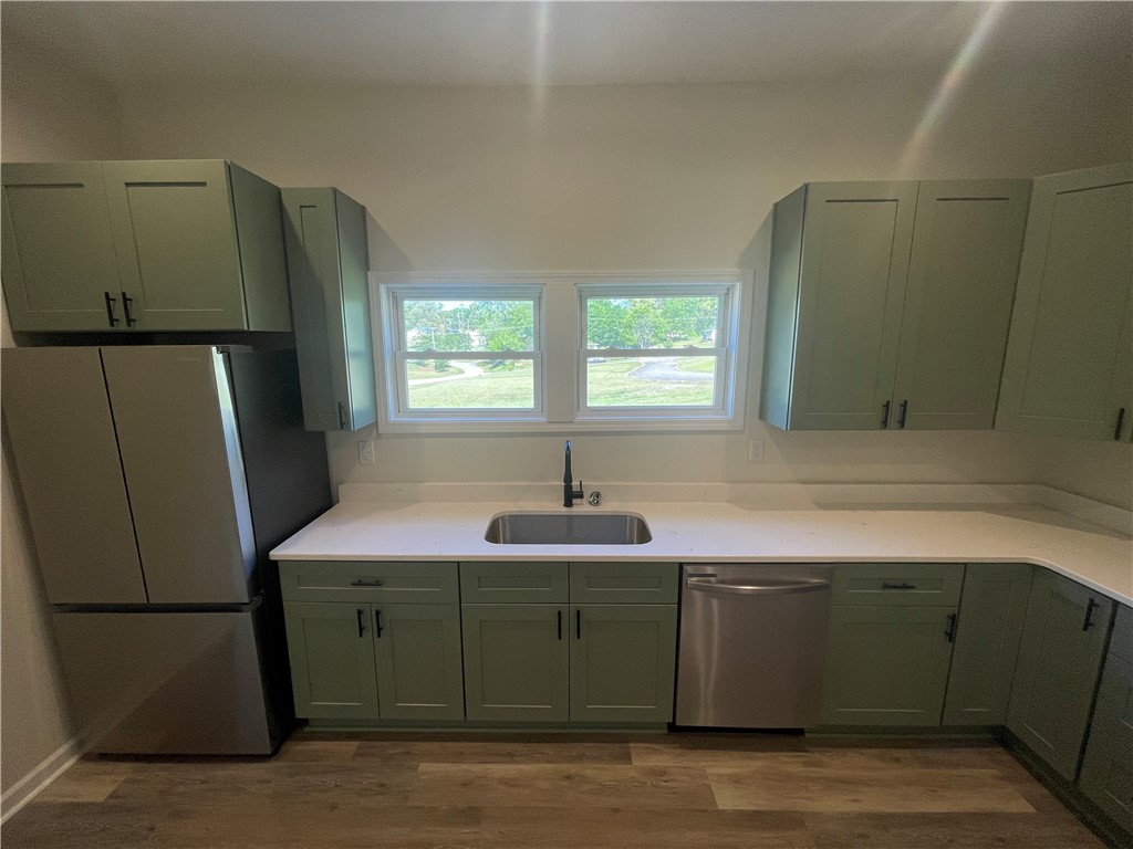 22 3rd Street Pendleton, SC 29670 - Photo 6 of 29 This bright kitchen features ample cabinetry, a generous sink, and durable flooring.
