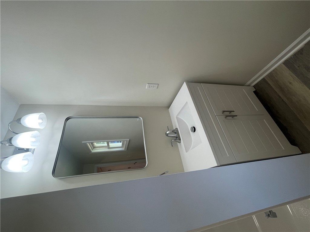 22 3rd Street Pendleton, SC 29670 - Photo 7 of 29 This sleek bathroom features a modern vanity and elegant lighting, creating a bright and inviting atmosphere.