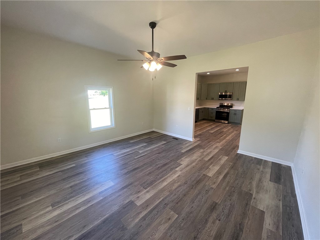 22 3rd Street Pendleton, SC 29670 - Photo 10 of 29 This inviting space features durable flooring and an open flow to the well-appointed kitchen.
