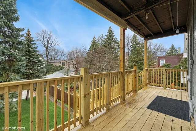 a view of a balcony with wooden floor
