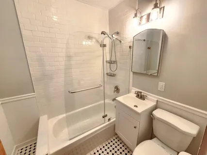 a kitchen with a refrigerator a sink a stove a refrigerator cabinets and wooden floor